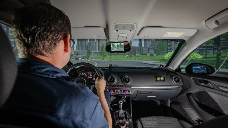 Male driving in a driving simulator.