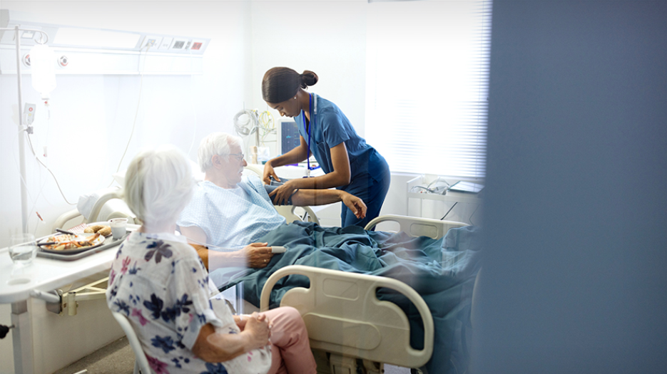 medical professional attending to patients in a hospital room
