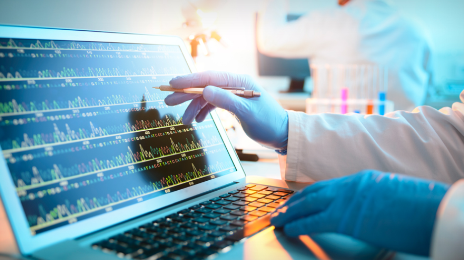 Person analyzing DNA sequencing data on a computer