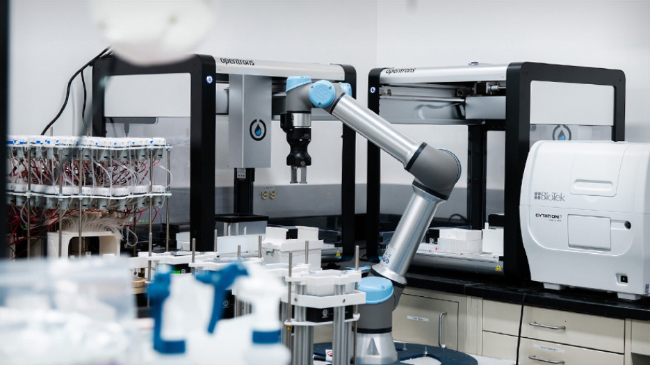 Photo of the lumi-lab setup, including lab equipment and robotic arm