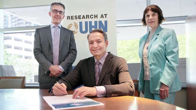 Dr. Kevin Smith, UHN's Chief Executive Officer signed the charter during a meeting that was attended by Dr. Brad Wouters (left), Executive Vice President of Science and Research, and Emma Pavlov (right), Executive Vice President, Human Resources and Organ