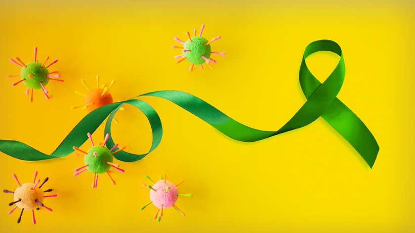 COVID-19 poses unique challenges for individuals who have received an organ or tissue transplant, symbolized by the green ribbon. Transplant recipients are at particular risk of severe COVID-19 and commonly experience reduced benefits from vaccines.