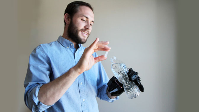 The HERO Glove could help individuals unable to extend their hands to carry out daily tasks, such as grasping a water bottle (pictured), while also promoting rehabilitation of the hand after injury.