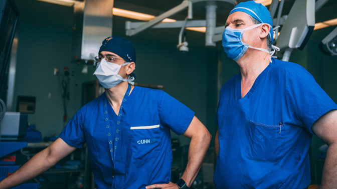 Drs. Spyridon Karadimas (left) and Dr. Michael Fehlings (right) in the operating room at Toronto Western Hospital.