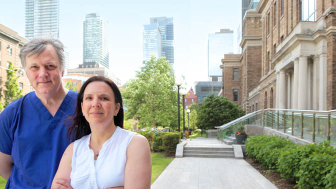 Drs. Ian McGilvray (left) and Sonya MacParland (right) pictured outside of the original brick faade of the old Toronto General Hospital.