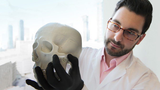 Dr. Michael Floros (pictured) demonstrates how BoneTape molds and adheres to the delicate bones in the face. The innovative adhesive was inspired by the way mussels stick to rocks underwater.